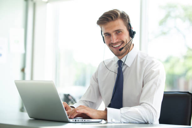 istock Happy young male customer support executive working in office. 1033657558