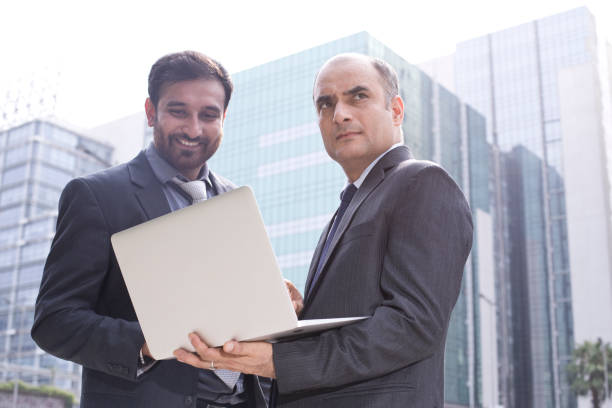 istock Two businessmen with laptop in city 1033657762