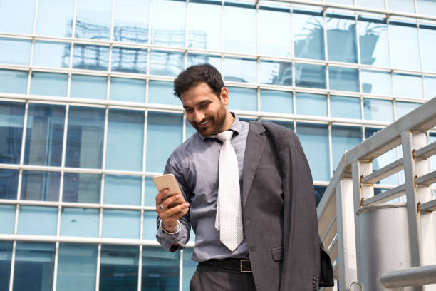 istock Businessman texting on mobile phone 1033662018