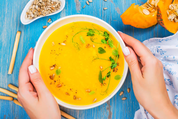 istock Pumpkin soup on blue wooden table 1033666240