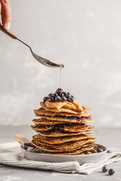 istock Stack vegan blueberry pancakes with peanut butter and syrup. 1033669316