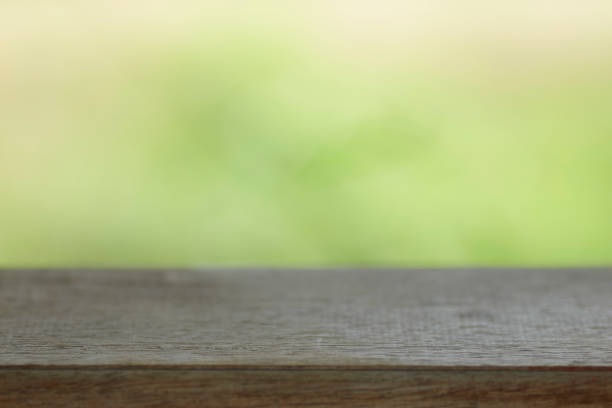 istock Wood table top on blur nature background 1033670038