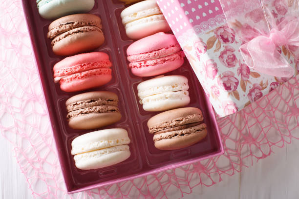 istock Beautiful food: French macaroons in a gift box close-up on a table. Horizontal top view 1033673122