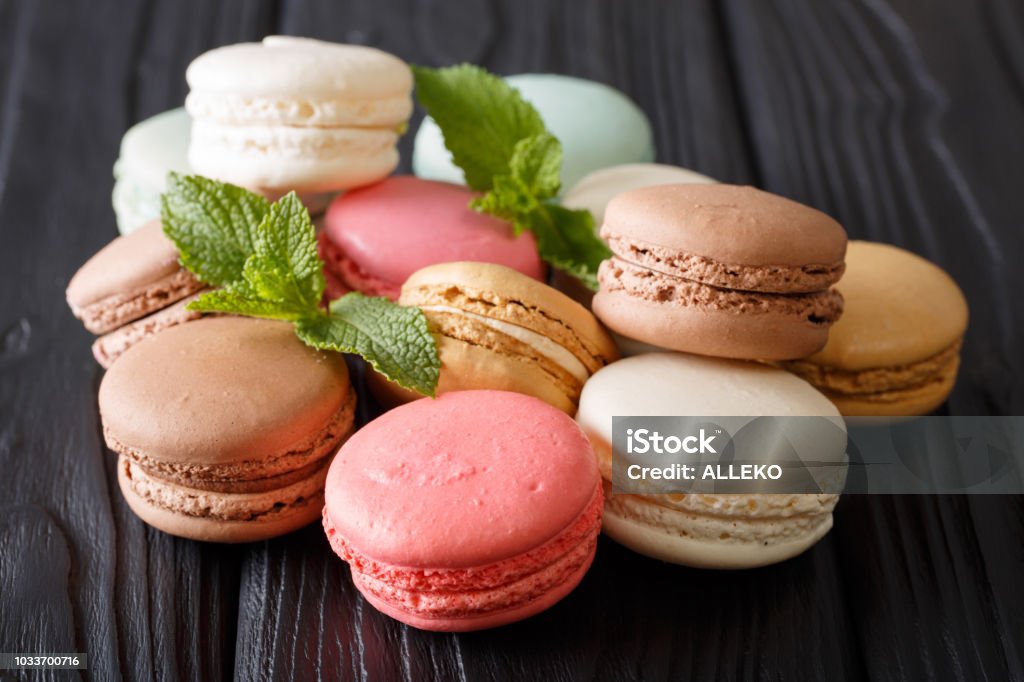 Beautiful colored macaroons in the assortment, close-up on the table. Horizontal Beautiful colored macaroons in the assortment, close-up on the table. Horizontal background Retro Style Stock Photo
