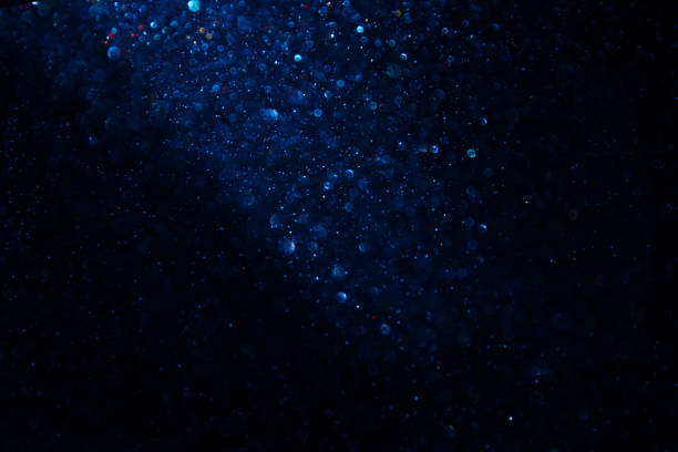 istock glitter vintage lights background. black and blue. de-focused. 1033703606