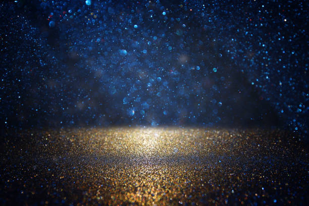 istock glitter vintage lights background. black, blue and gold. de-focused. 1033703758