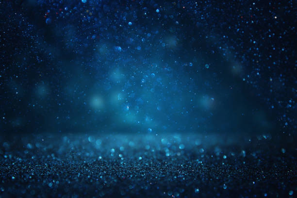 istock glitter vintage lights background. black and blue. de-focused. 1033703790
