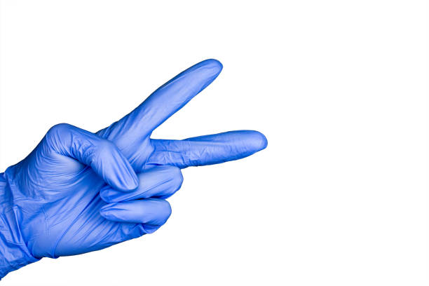 istock hand gesture in blue medical glove isolated 1033706746