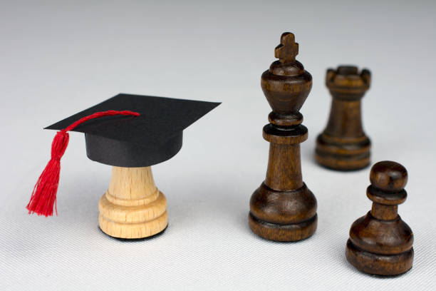 istock white chess piece in a graduation cap on white background 1033707400