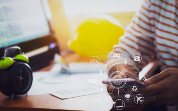 istock Architecture in casual dress holding mobile phone with online while making orders with virtual icon diagram in office. 1033707424