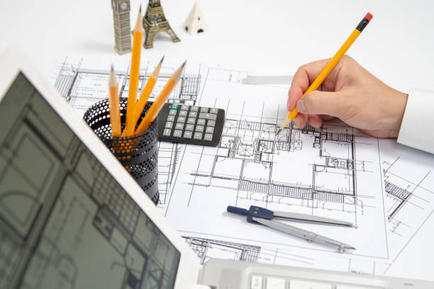 istock The hand of a male architect drawing a design using a pencil. 1033711078