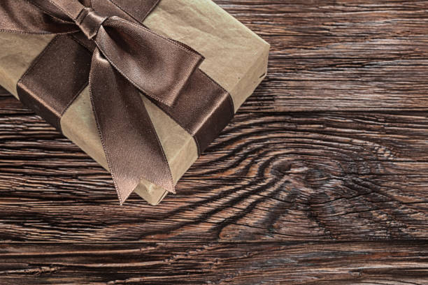 istock Brown gift box on vintage wooden board horizontal image 1033716480