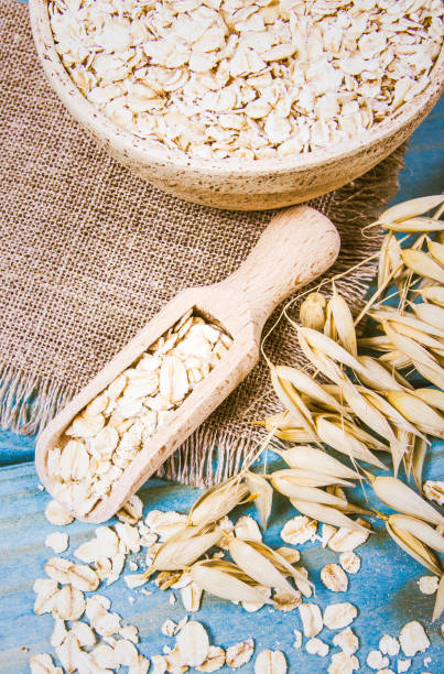 istock Oat flakes in a bowl on the blue board. 1033723572