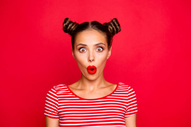 istock Oops! Closeup portrait of shocked impressed model with red lips with unexpected unbelievable reaction looking at camera with wide open eyes and mouth isolated on red background 1033727114