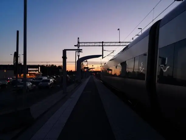 The train and the horizon as the midnight sun is across the sky.