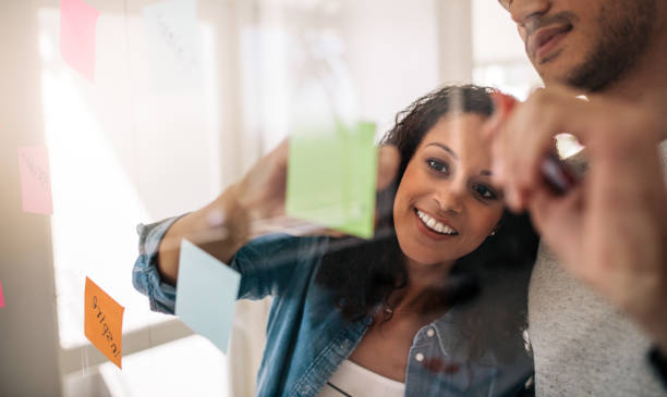 istock Business colleagues discussing work on a glass board in offic 1033736010