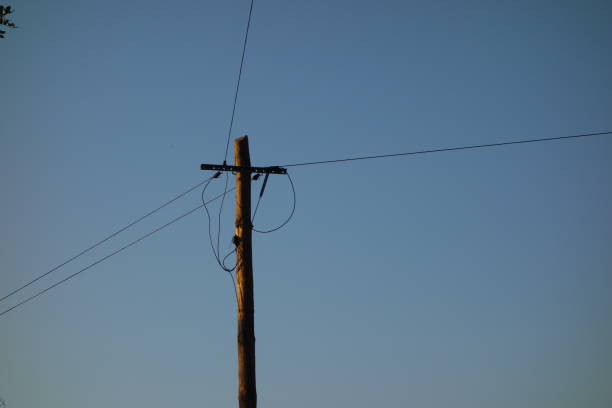 istock Electricity pole and cables on blue sky 1033740086
