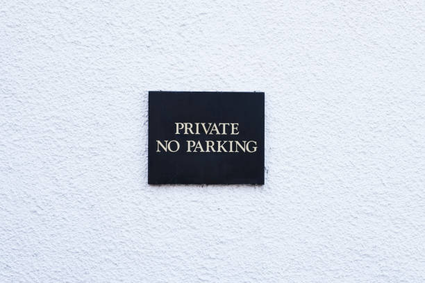 istock No parking private minimal black sign on empty white wall 1033743116