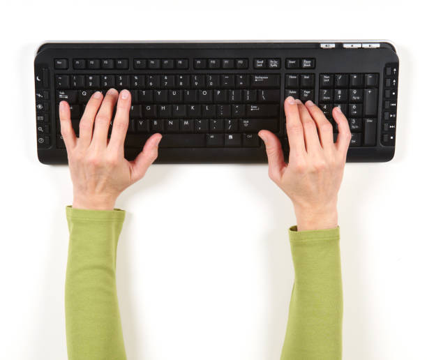 istock Hands in green jacket and black keyboard 1033743242
