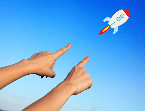 istock Female hands point to the rocket 1033743710