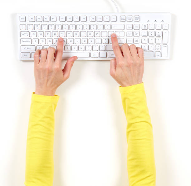 istock Hands in yellow jacket and white keyboard 1033743766