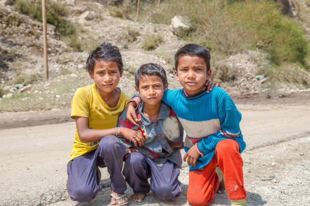 retrato de crianças pobres se divertindo na rua rural da cidade indiana - india slum poverty family - fotografias e filmes do acervo