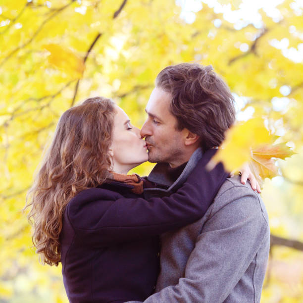istock Couple kiss in autumn forest 1033753432