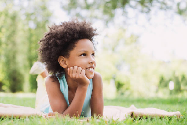 istock Beautiful little kid girl lying on a grass 1033753510