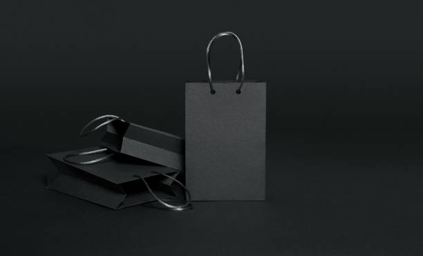 Black paper shopping bags on black background Black Friday, Shopping Bag, Black background, retail, luxury, masculinity, copy space luxury craft stock pictures, royalty-free photos & images