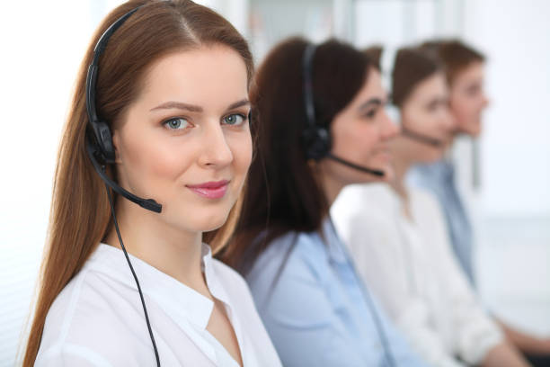 istock Call center. Beautiful cheerful smiling operator consulting clients with headset. Business concept of customer service. 1033757030