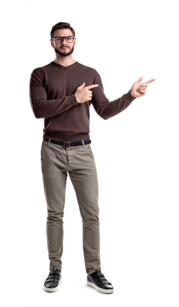istock A bearded man in smart casual clothes looks straight and points sideways with both hands on a white background. 1033766012