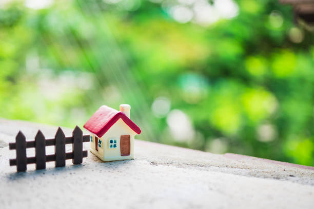 Miniature house on green nature background using as family and property concept