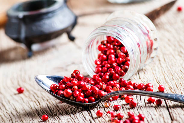 istock Pink pepper rose in a glass jar and spoon 1033768618
