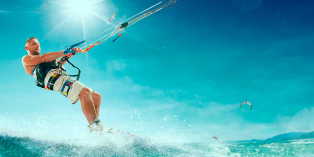 istock Kitesurfing. Man rides a kite 1033768920