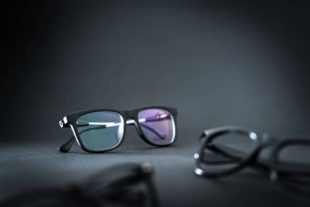 istock New eyeglasses and different specs on table in ophthalmology or optometry clinic. Glasses in dark. 1033774286
