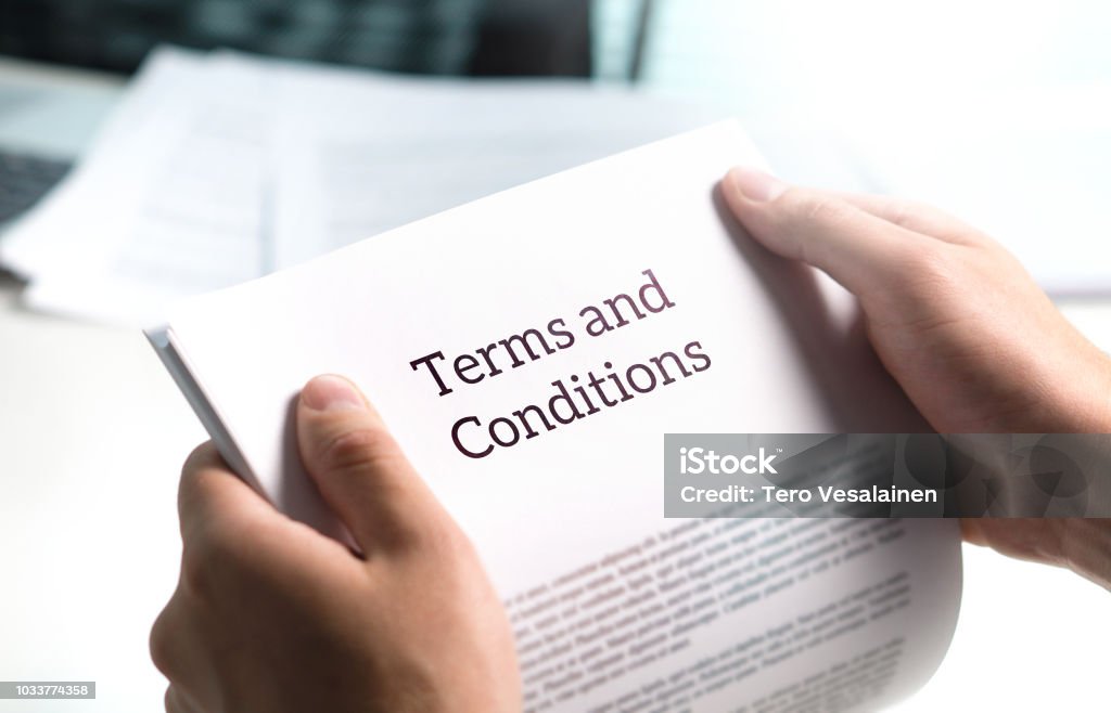 Terms and conditions text in legal agreement or document about service, insurance or loan policy. Terms and conditions text in legal agreement or document about service, insurance or loan policy. Lawyer or client holding contract paper in office. Terms And Conditions Stock Photo