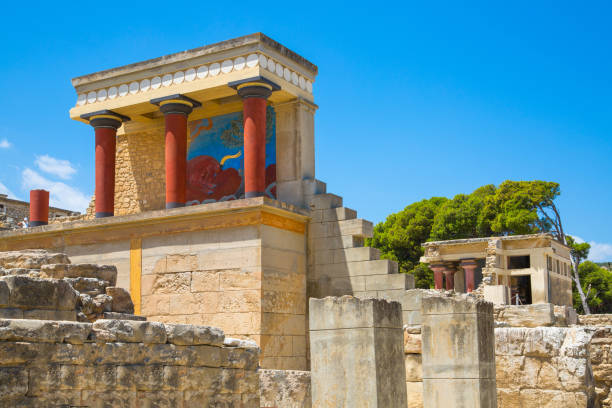 Parade facade of the Knossos palace with sacred bull fresco. Iconic part of the surviving Knossos palace. Greece, Crete Greece, Crete, Heraklion - July 18, 2018:Parade facade of the Knossos palace with sacred bull fresco. Archaeological sight connected with legends of Daedalus, Minotaur, Ariadne and Icarus minotaur photos stock pictures, royalty-free photos & images