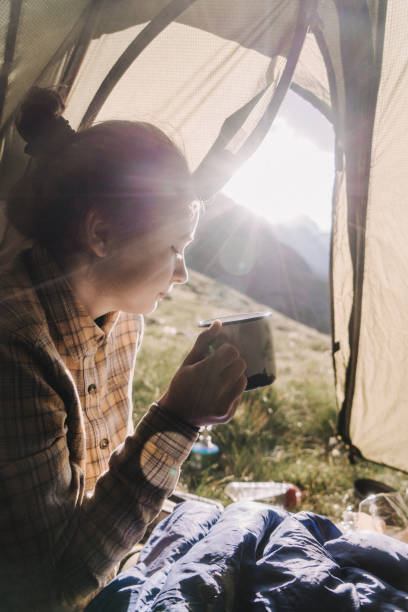 istock Woman drinking from cup  in the tent 1033777276