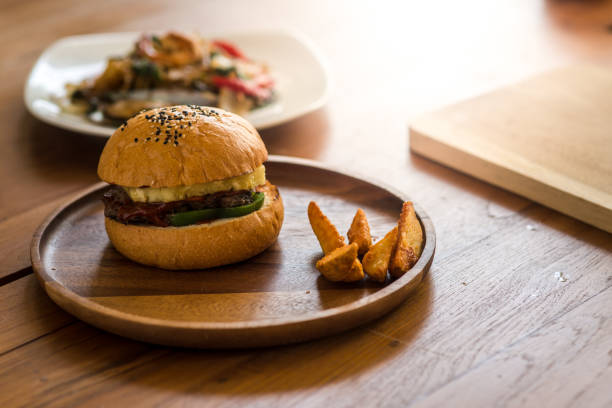 istock Meat burger on wooden plate, ready to serve. 1033779766