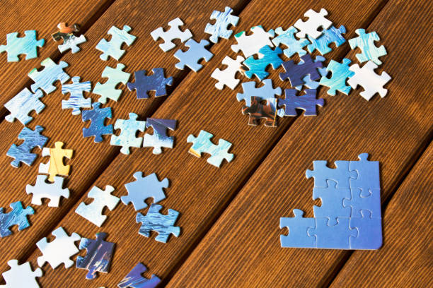 istock Pieces of different puzzles on a wooden table. The concept of thinking development 1033782872