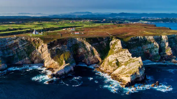 Aerial Photograph of Cabo de Peñas with the lighthouse and cliffs. Asturias Spain.