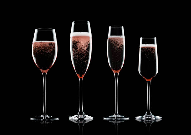istock Rose pink champagne glasses with bubbles 1033786054