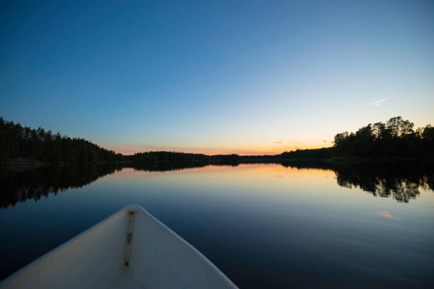 A motorboat at a jetty at sunset on a calm evening in Kimito island, Finland.