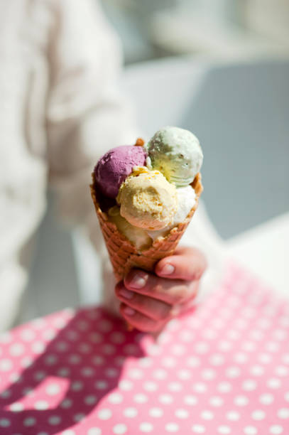 istock young man eats colorful ice cream in a cafe 1033795428