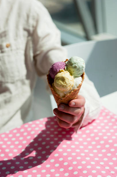 istock young man eats colorful ice cream in a cafe 1033795436