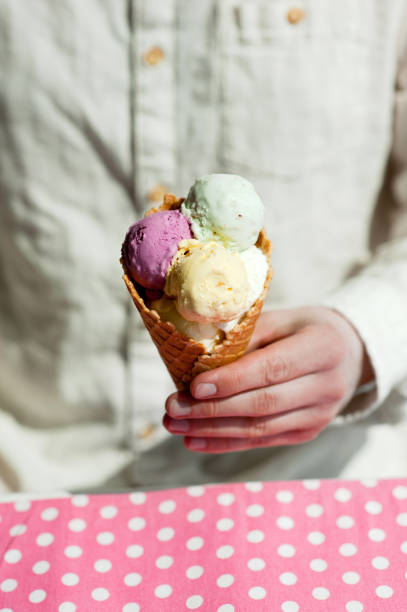 istock young man eats colorful ice cream in a cafe 1033795442
