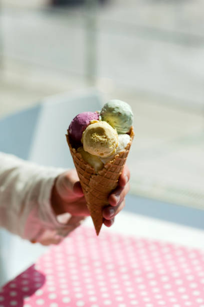 istock young man eats colorful ice cream in a cafe 1033795444