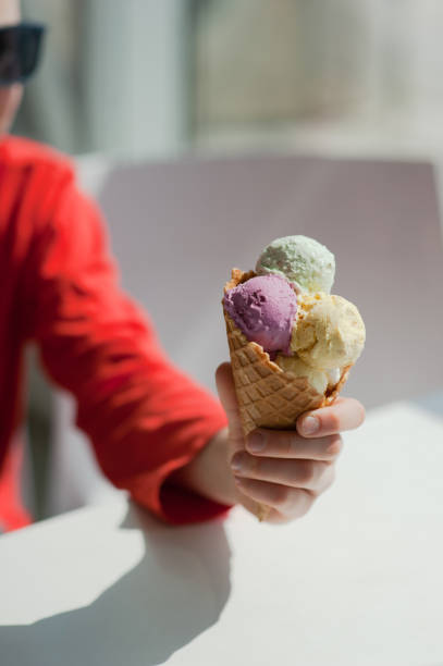istock young man eats colorful ice cream in a cafe 1033795456