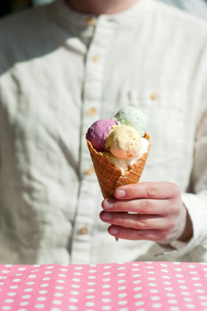 istock young man eats colorful ice cream in a cafe 1033795466