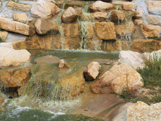 istock Small waterfall and wooden footbridge 1033795716
